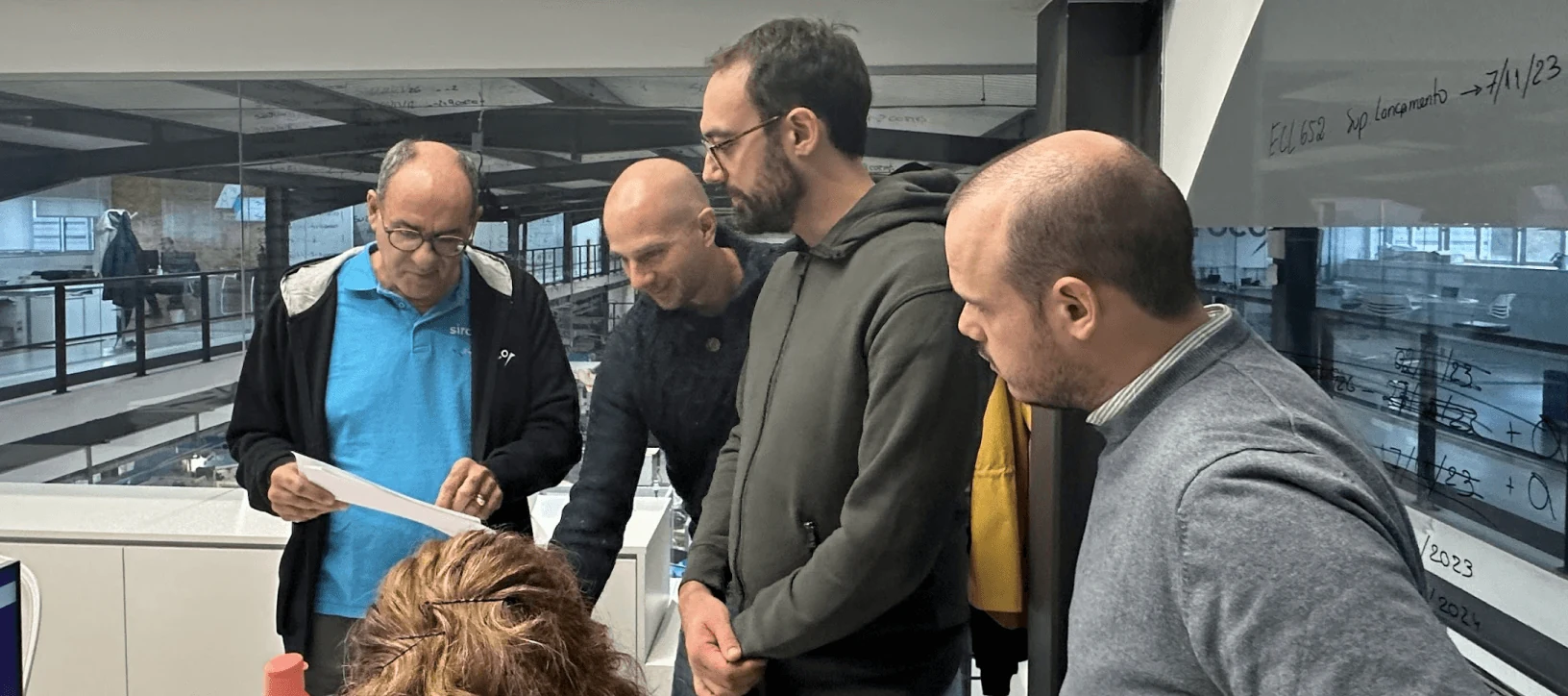 SIROC operators reviewing plans with a client team on the factory floor