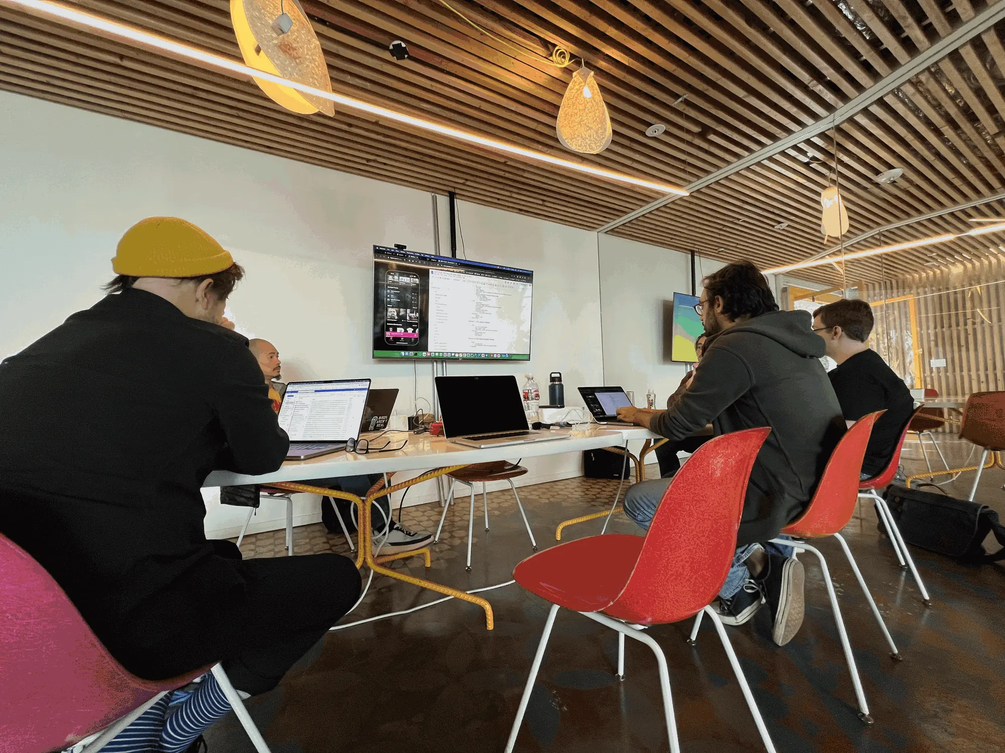 The SIROC team around a table of laptops, with the Chorus app up on the wall screen.