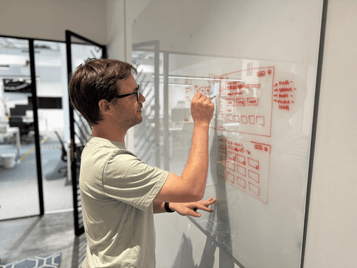 A SIROC engineer mapping a system out on a whiteboard