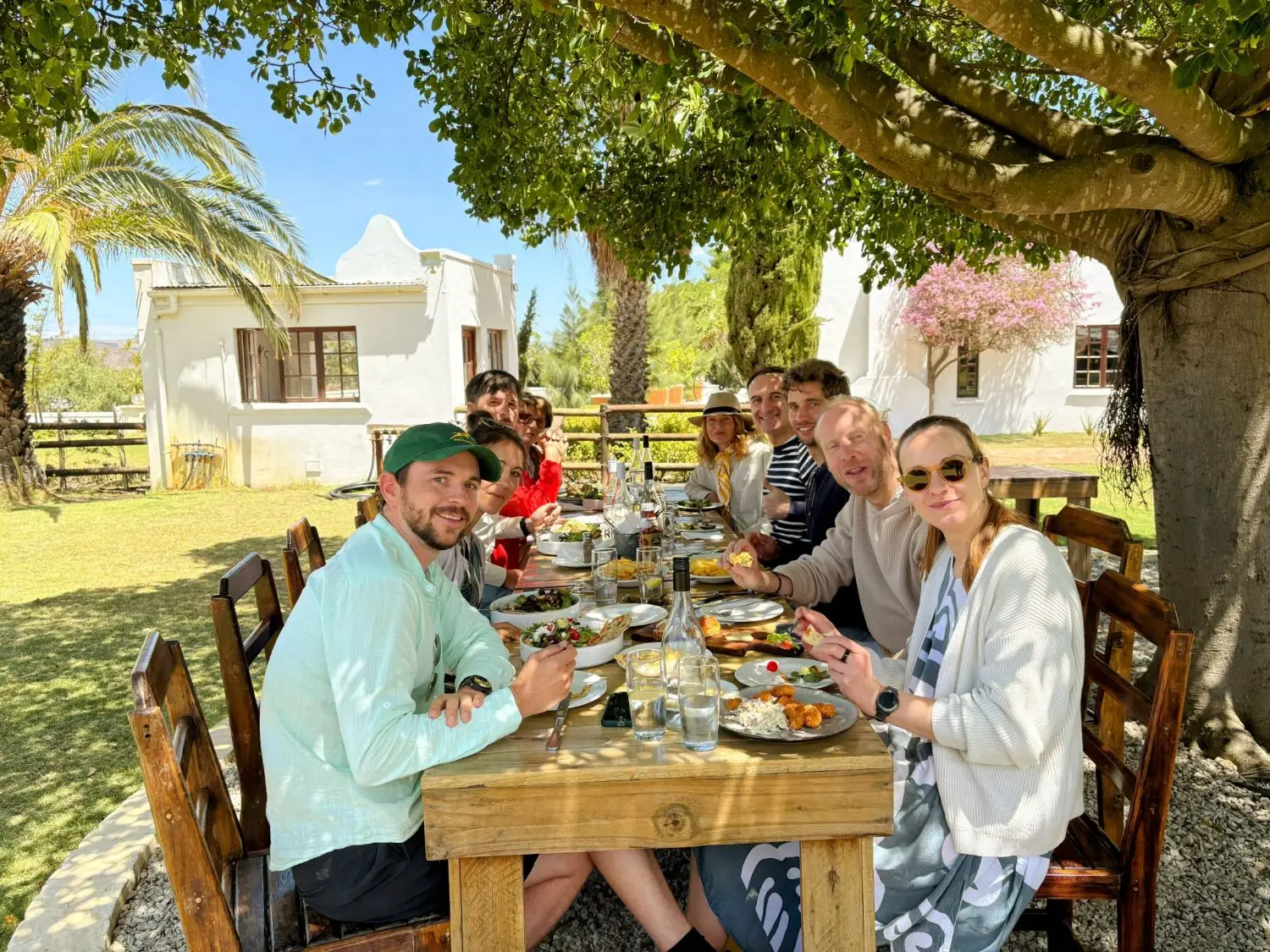 SIROC and partners at a long lunch under a tree
